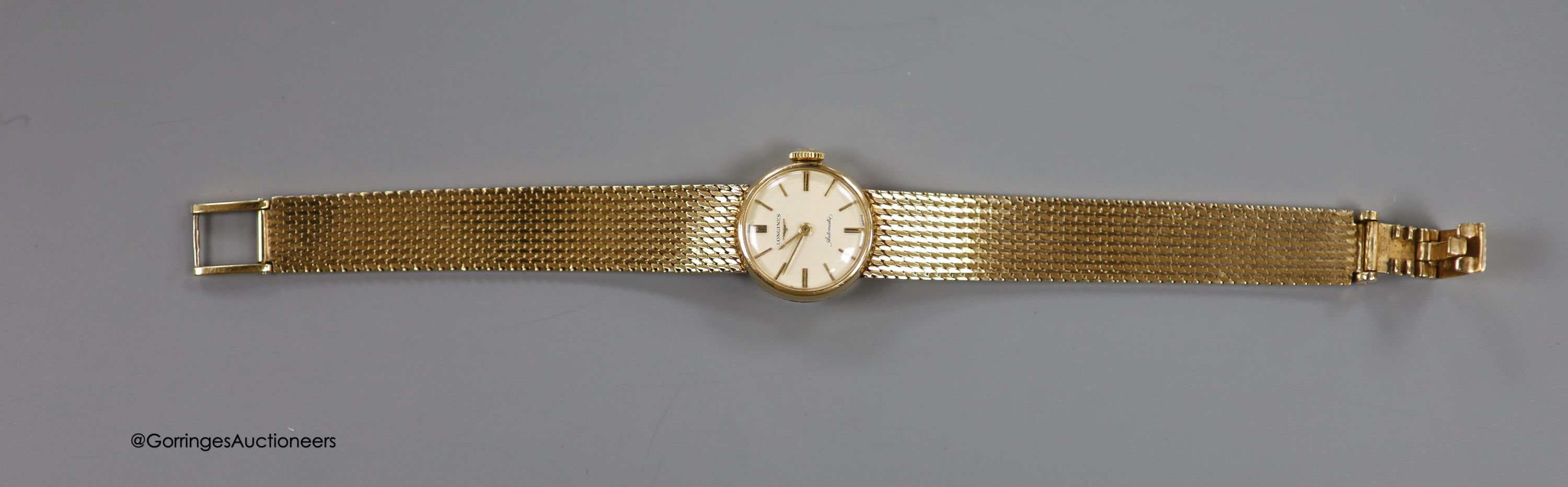 A lady's 9ct gold Longines manual wind wrist watch, on a 9ct gold bracelet, case diameter 20mm, gross weight 31.1 grams, in Longines box.